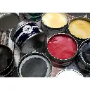 Gamblin-Relief-Ink-jars-on-a-dark-wooden-background.webp