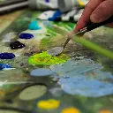 094376976878-LQX SMALL PAINTING KNIFE BEING HELD ON PALLET WITH LIME GREEN PAINT (For Office Print).webp